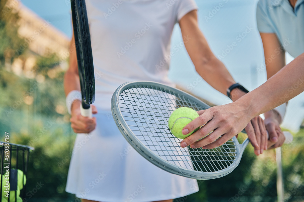 Tennis training, hands and ball with women and athlete on outdoor turf, instructor or coach, fitness