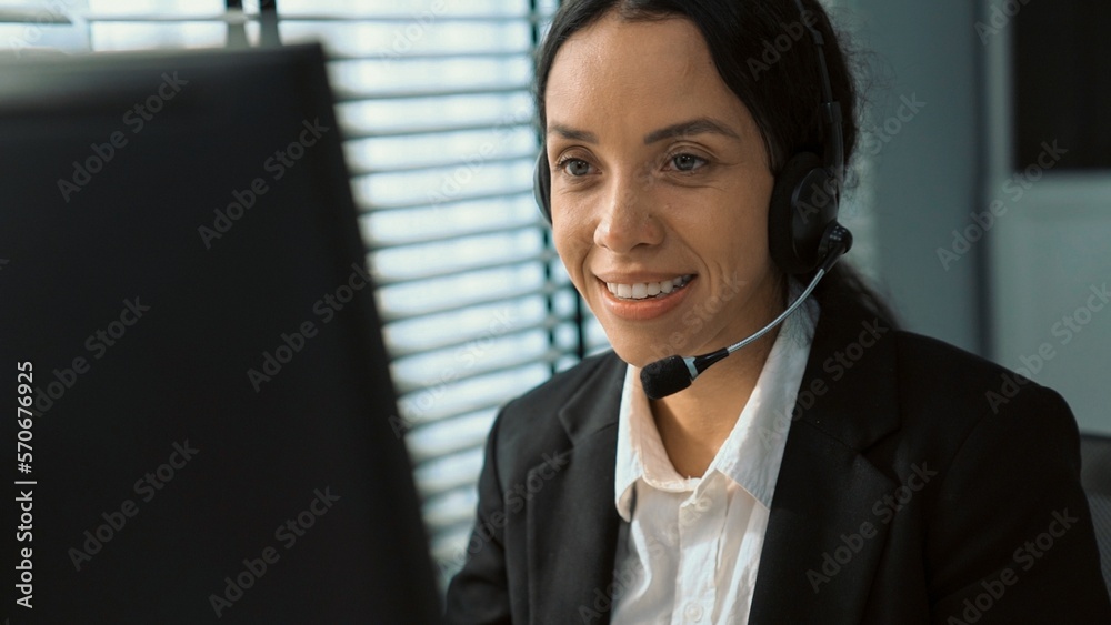 Competent female operator working on computer and talking with clients. Concept relevant to both cal