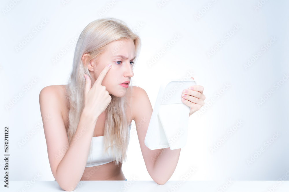 Acne problem troubling personable worried woman with natural beauty skin checking her face squeezing