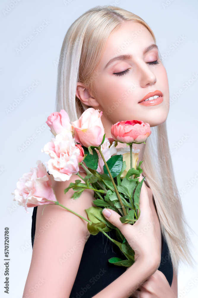 Closeup young personable woman with natural makeup and healthy soft skin holding rose for beauty car