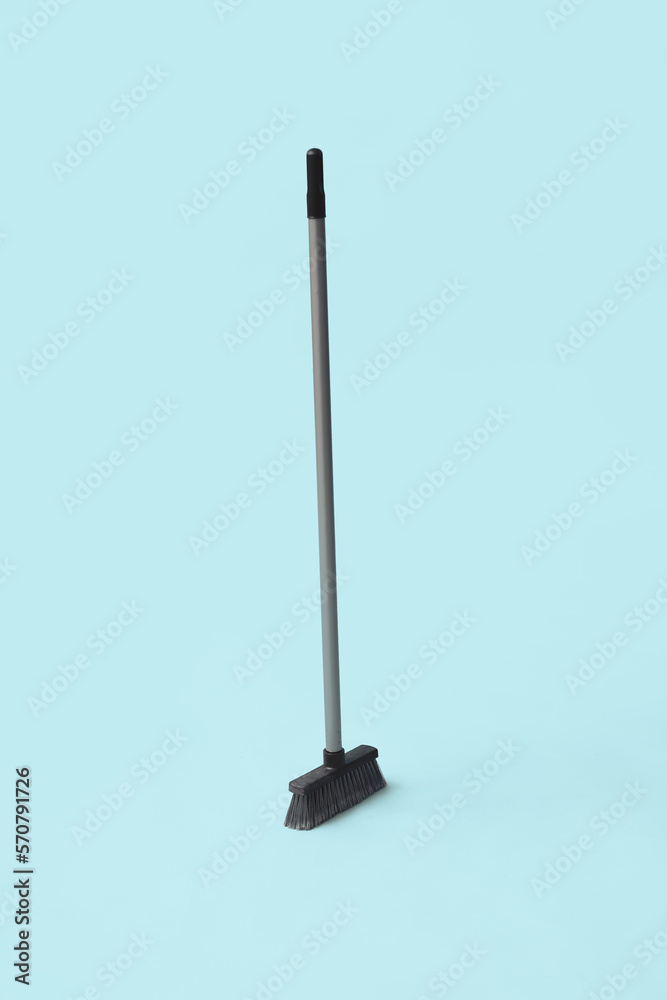 Plastic sweeping broom on color background