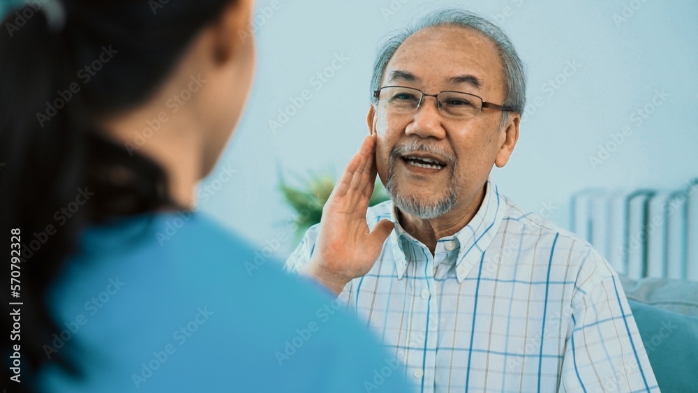 A young female doctor inquires about personal information of a contented senior at home. Medical car