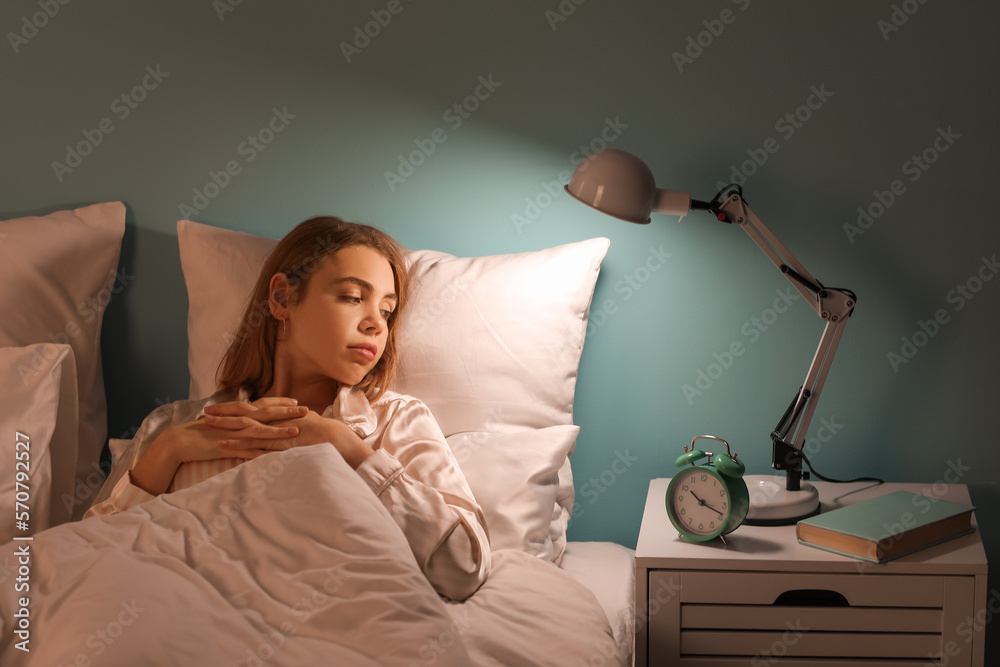 Young woman cannot sleep in bedroom at night