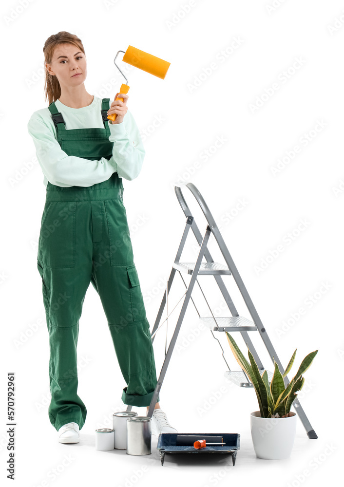 Young woman with roller, ladder, houseplant and paint cans on white background