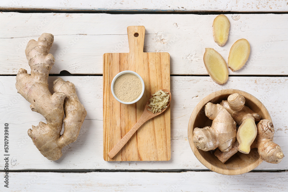 Composition with melted ginger, roots and slices on light wooden background