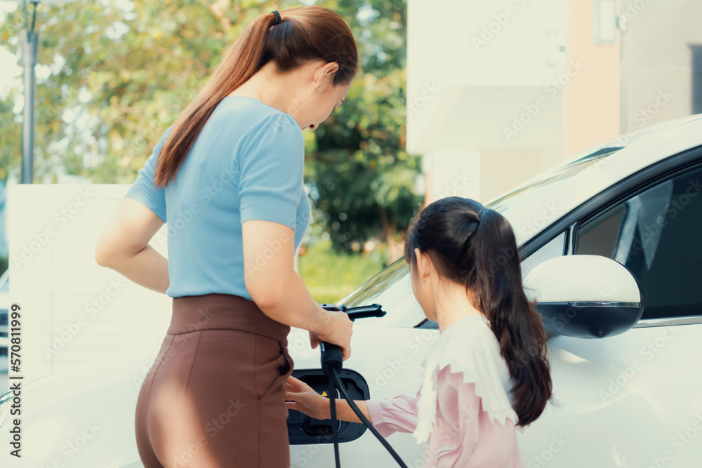 Progressive lifestyle of mother and daughter who have just returned from school in an electric vehic