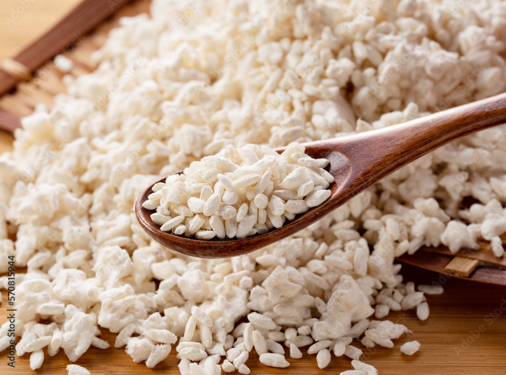 Rice koji in a colander on the table and a wooden spoon.