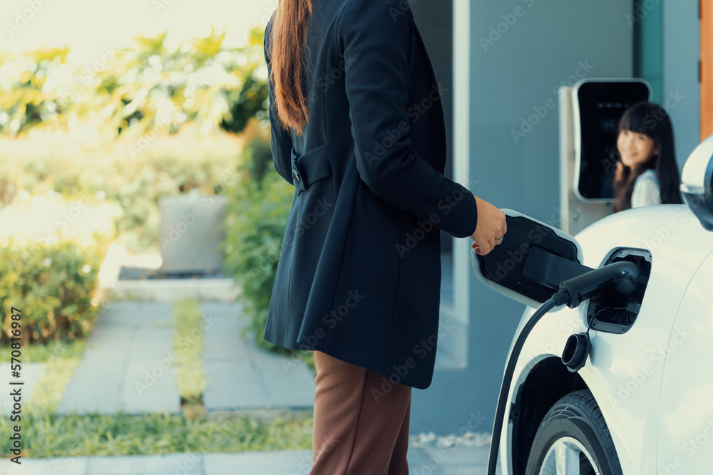 Progressive lifestyle of mother and daughter who have just returned from school in an electric vehic