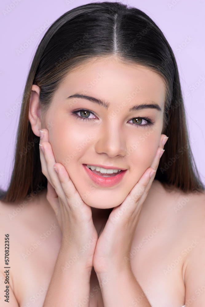 Portrait of young brunette with long hair and flawless skin with hand gesture for beauty and cosmeti