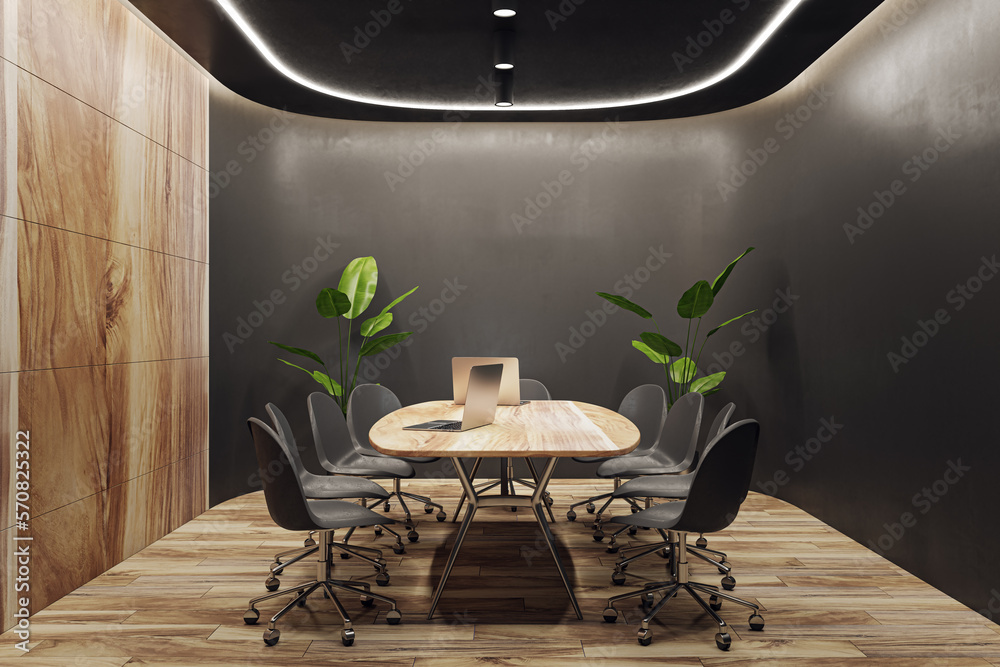 Modern wooden and black meeting room interior with equipment, furniture and decorative plants. Comme