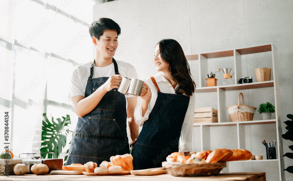 Asia lovers or couples cooking in kitchen with full of ingredient with Bread and fruiton table.Valen