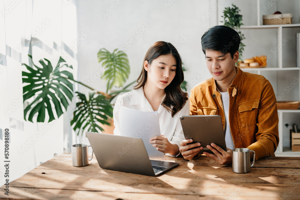 Portrait of success Asian business people working together in home office. Couple teamwork startup c