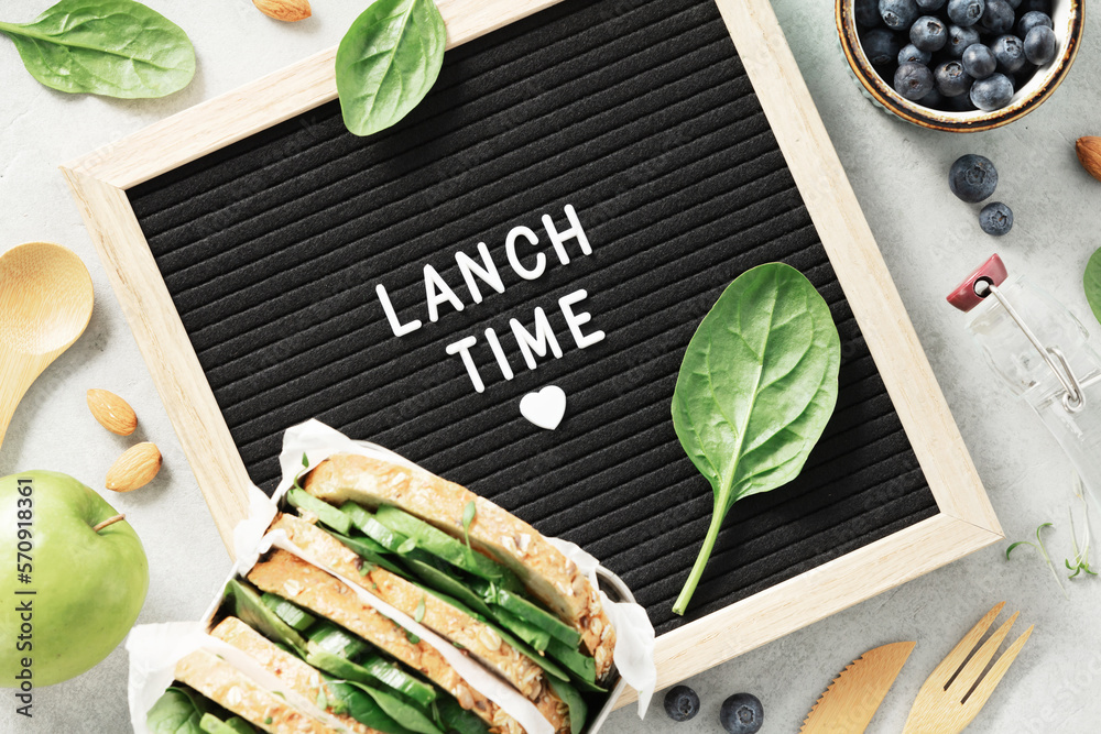 Lunch time letter board and  healthy food flat lay