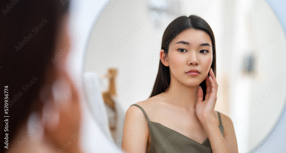 woman looking at mirror