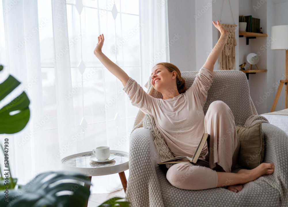 woman enjoying book and tea