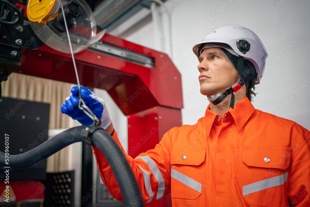 Engineers mechanic using computer controller Robotic arm for welding steel in steel factory workshop