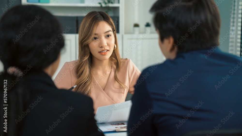 A young female asian candidate tries to impress her interviewer by being competent. International co