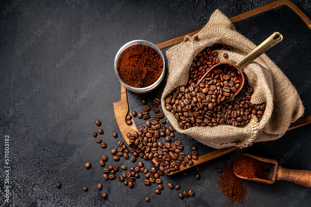 Scoop of coffee beans in a bag on dark board. Top view of ground coffee in a cup and instant coffee 