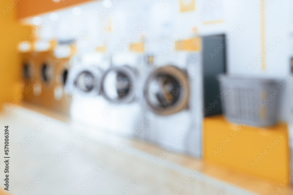 Blur background of of qualified coin-operated washing machines in a public store. Concept of a self 