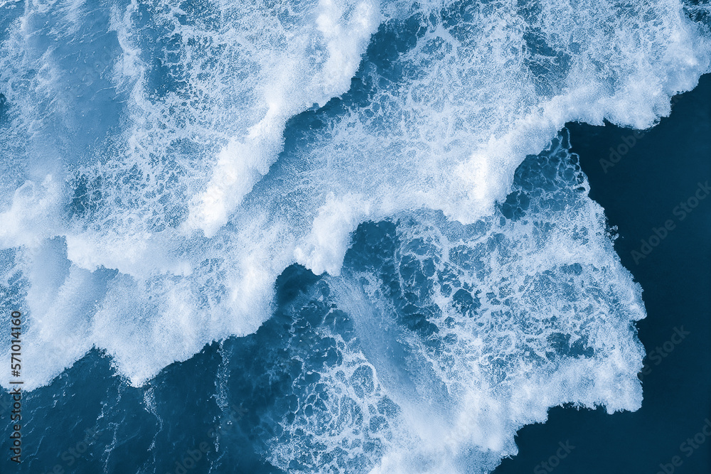 Spectacular aerial top view background photo of ocean sea water white wave splashing in the deep sea