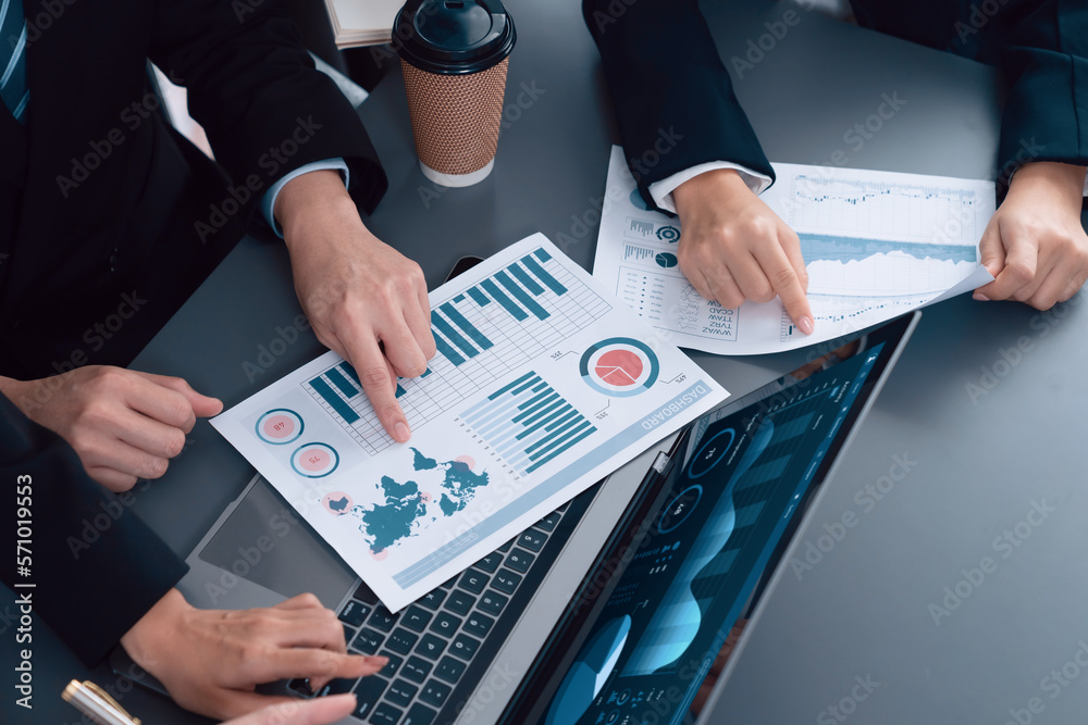 Closeup on meeting desk with businesspeople analyzing business marketing strategy with hands working