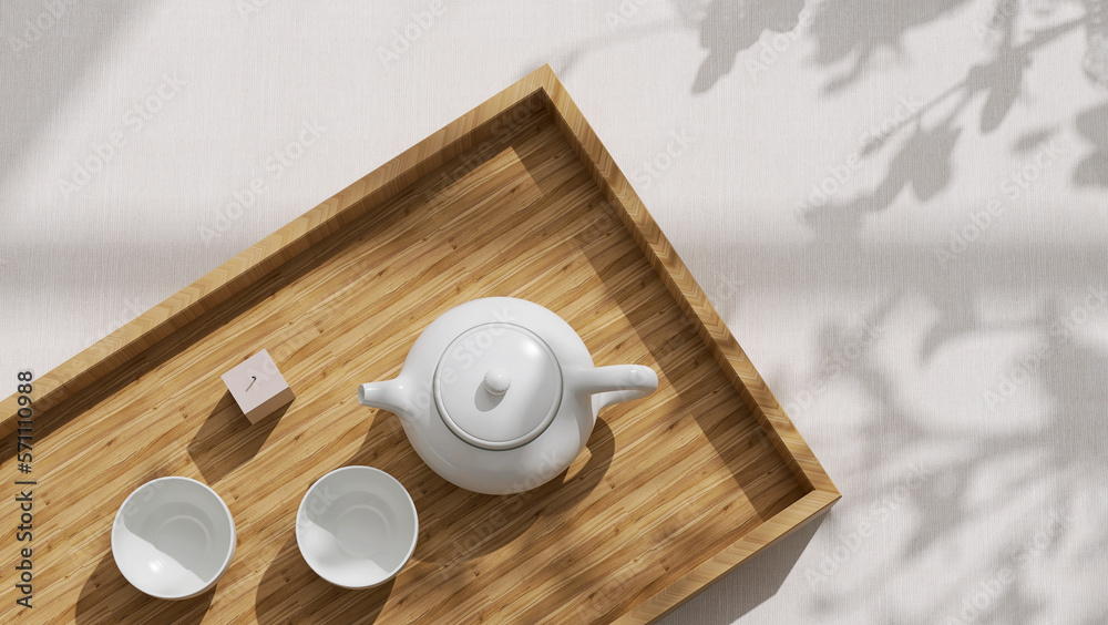 Top view of minimal, beautiful white ceramic teapot, two teacup, candle on brown wooden tray on crea