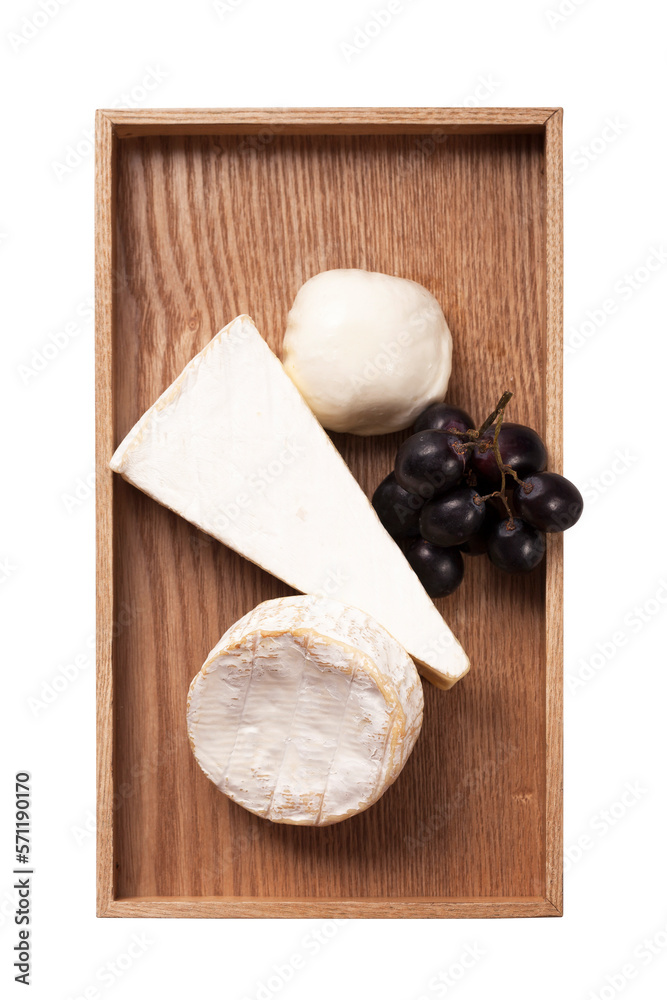 Various cheese and grapes on wooden plate isolated on background