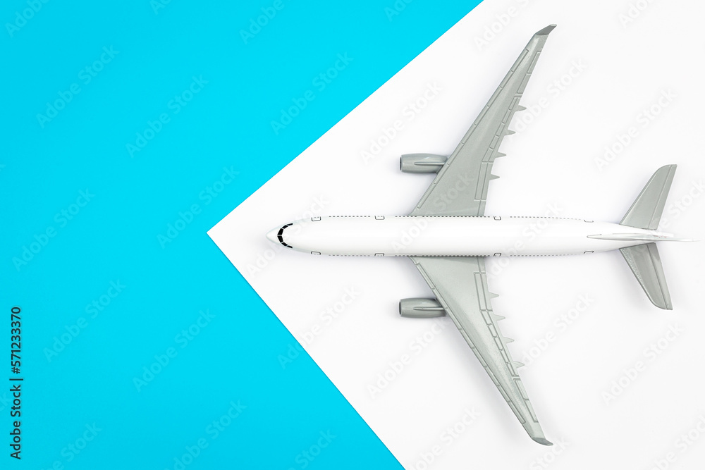 A plane, airplane on a blue background, flat lay, copy space.