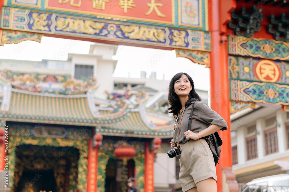 Young Asian woman backpack traveler enjoying China town street food market in Bangkok, Thailand. Tra