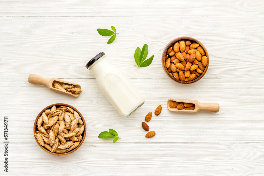 Sweet almond milk in bottle with almond seeds