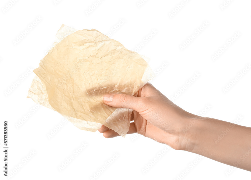 Female hand with sheets of baking paper on white background, closeup