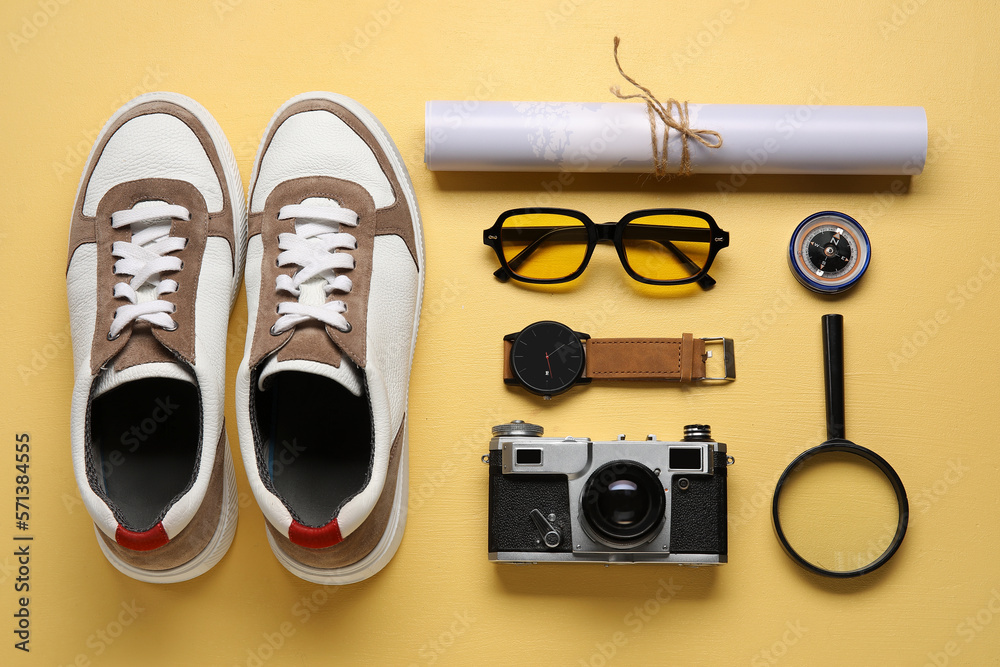 Compass with traveler accessories on yellow background