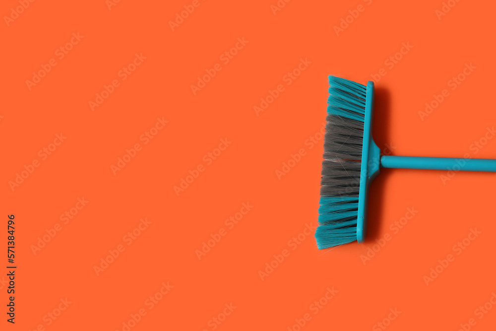 Blue broom for cleaning on color background