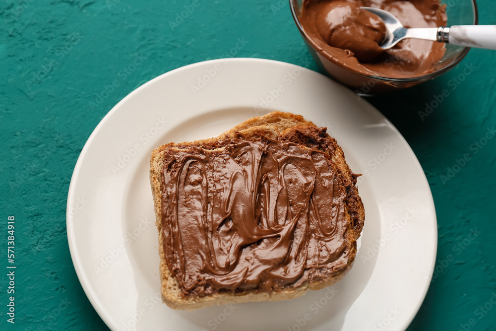 Plate of tasty toasts with hazelnut butter on color background, closeup