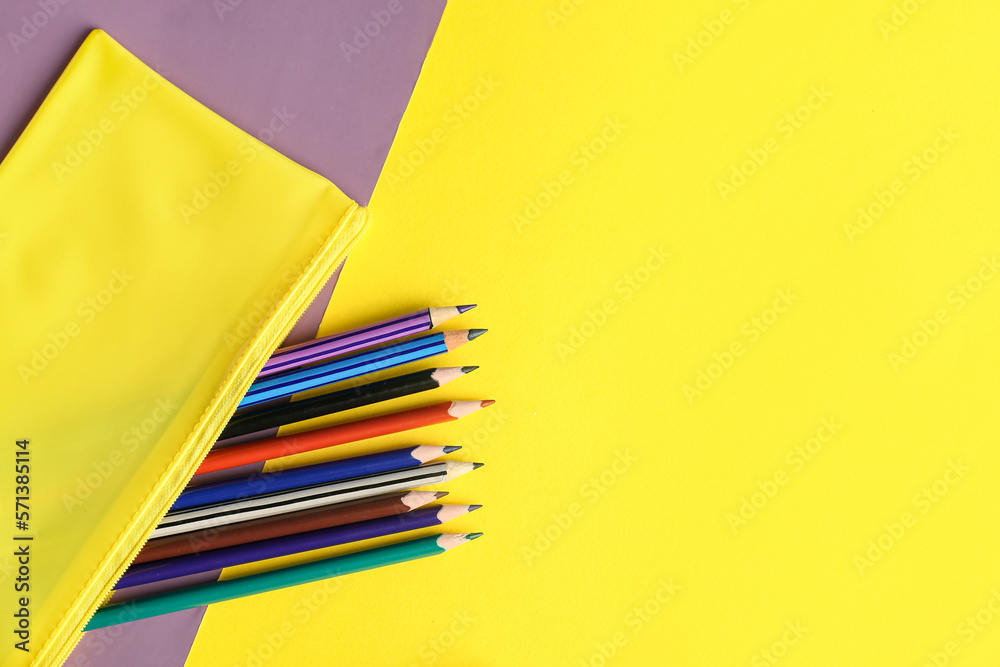 Case with colorful pencils on color background