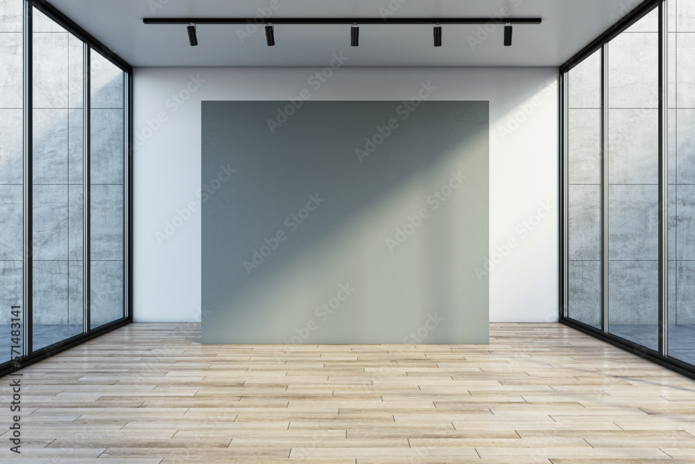 Front view on sunlit big blank grey partition with space for your logo or advertising text on wooden