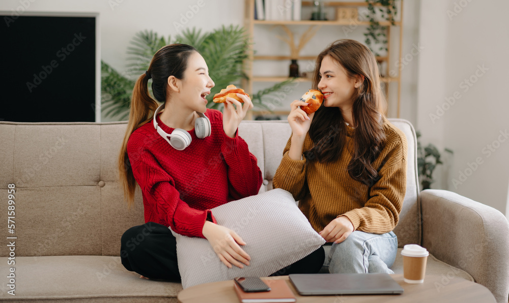 Two asian beauty smiling young women sitting on sofa Attractive casual girl feel happy and relax,hav