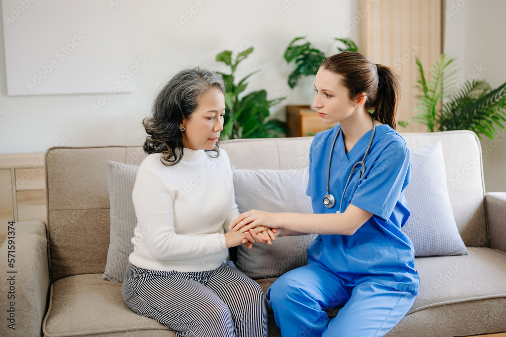 Asian female hands touching old female hand Helping hands take care of the elderly concept in  hospi