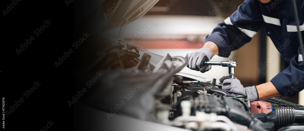 Mechanic works on the engine of the car in the garage. Repair service. Concept of car inspection ser