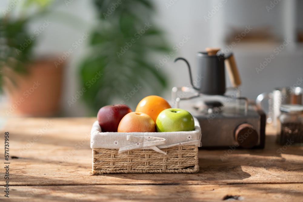 Lovely basket of fresh fruit with coffee up and coffee pot in the background.