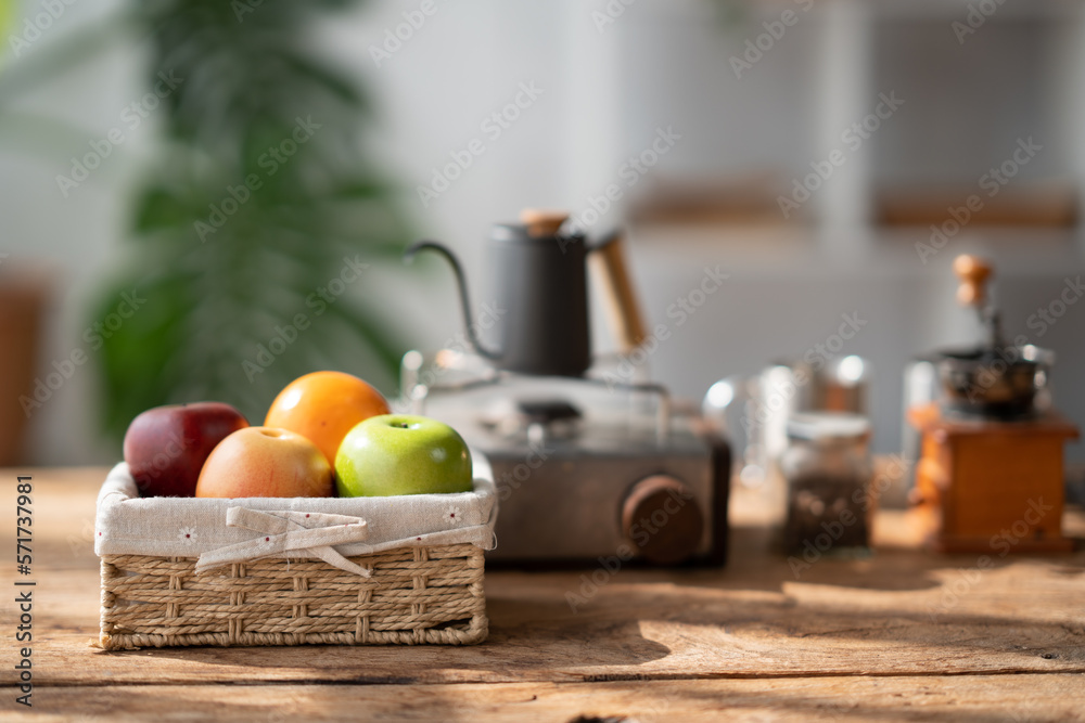 Lovely basket of fresh fruit with coffee up and coffee pot in the background.