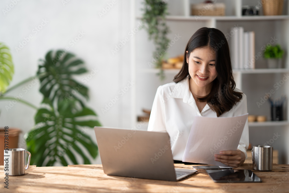 Young beautiful businesswoman using laptop computer in comfortable modern office room.