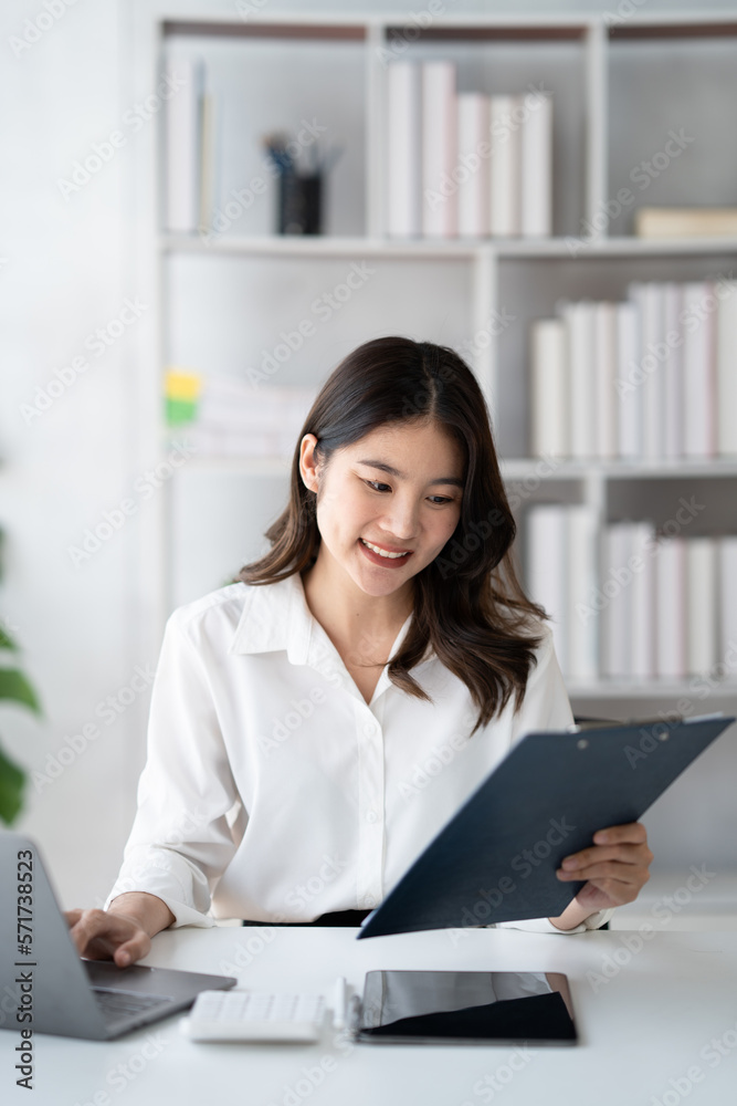 Portrait of young beautiful businesswoman working on her project in the office room, preparing for t