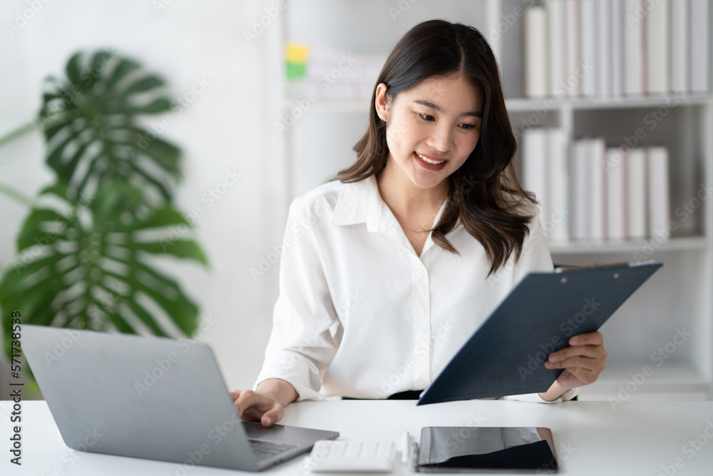 Portrait of young beautiful businesswoman working on her project in the office room, preparing for t