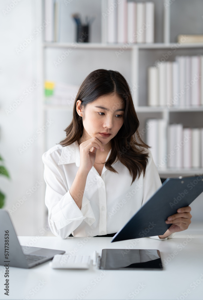 Portrait of young beautiful businesswoman working on her project in the office room, preparing for t