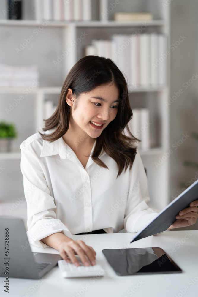 Portrait of young beautiful businesswoman working on her project in the office room, preparing for t