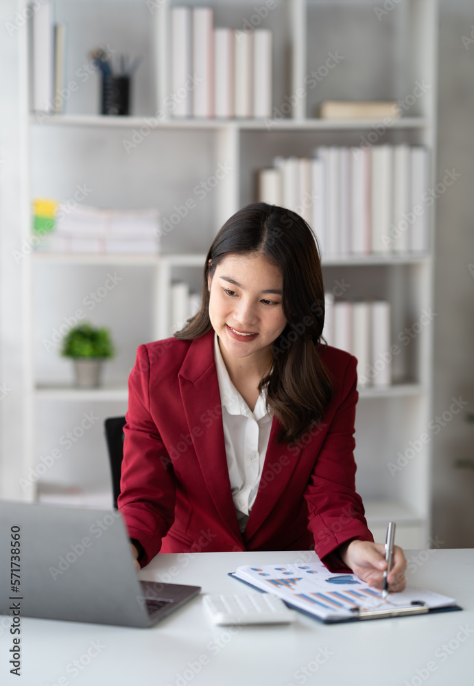 Portrait of young beautiful businesswoman working on her project in the office room, preparing for t