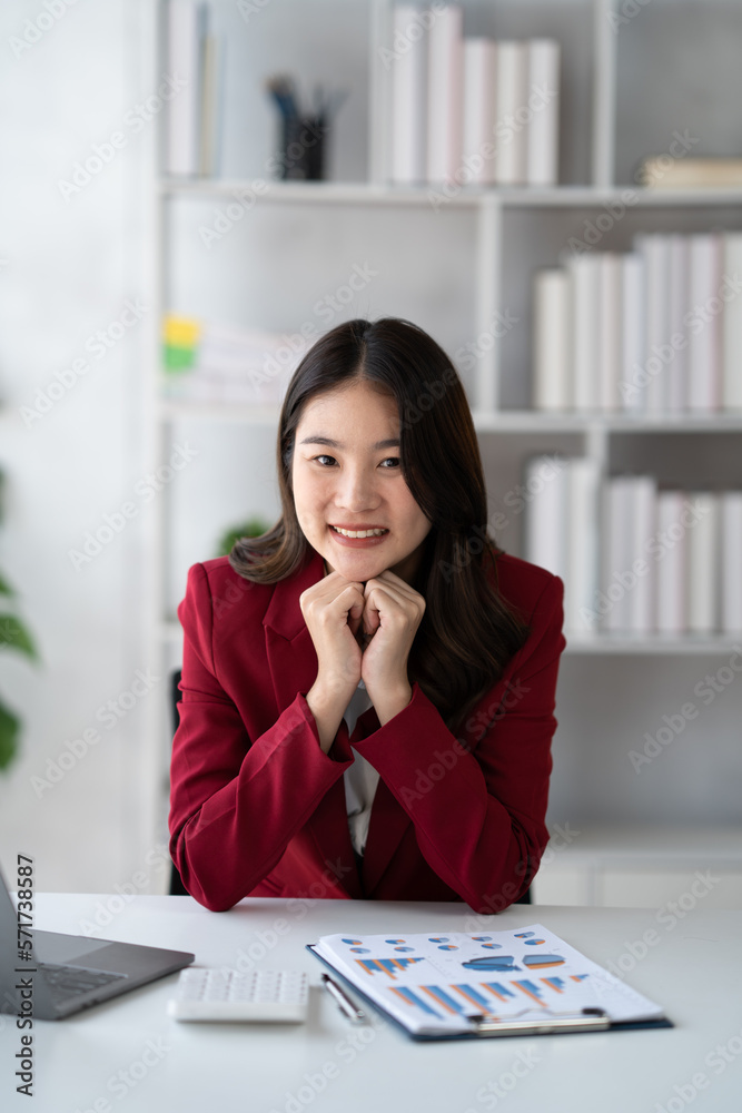 Portrait of young beautiful businesswoman working on her project in the office room, preparing for t