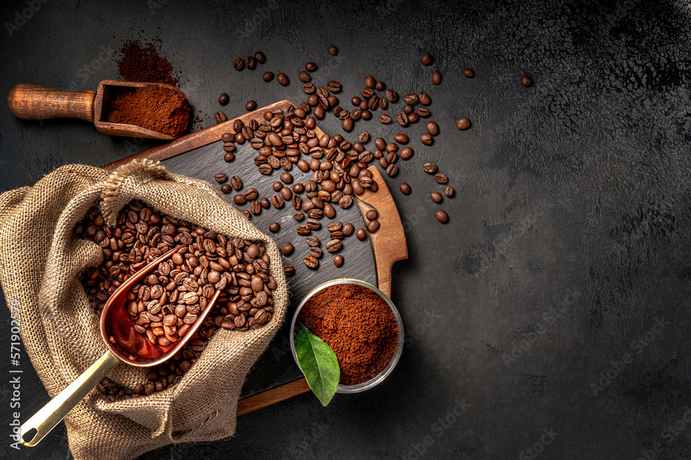 Scoop of coffee beans in a bag on dark board. Top view of ground coffee in a cup and instant coffee 