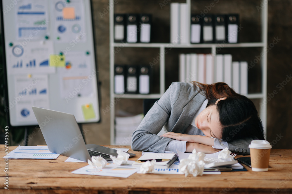 Asian business woman is stressed, bored, and overthinking from working on a tablet at the modern off